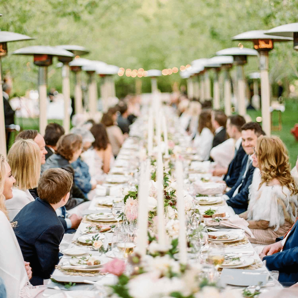 Elegant wedding catering: people sitting around the table waiting to eat.