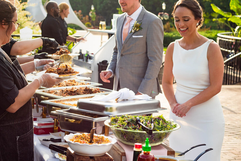 wedding catering: Bride and groom getting served their food by the caterers